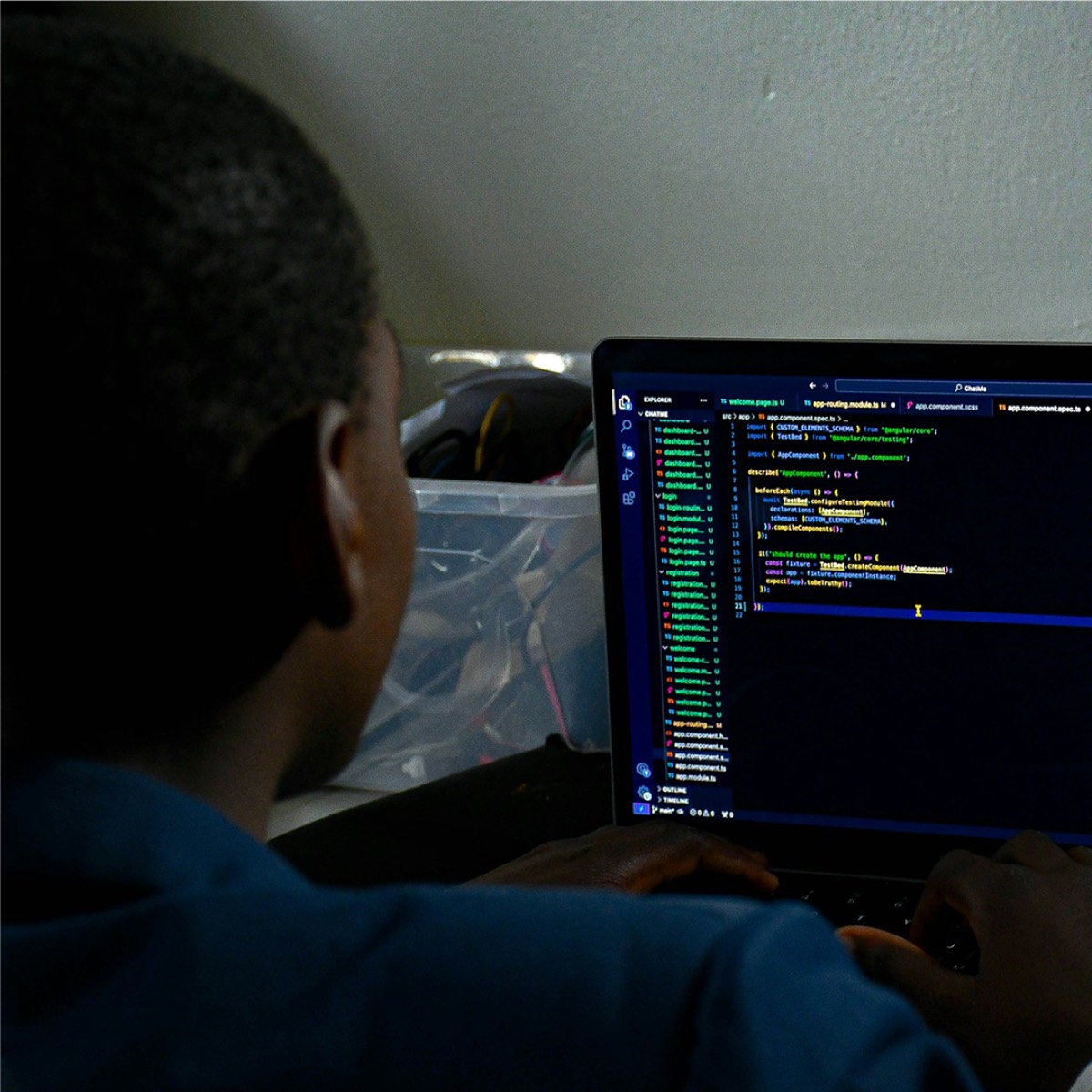 A developer working through code on a laptop